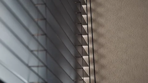 Light and shadow play on blinds and wall in a room Stock Footage 329011442