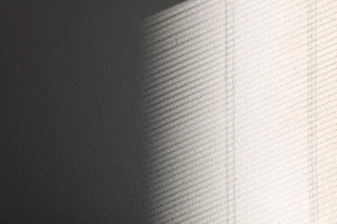 Light and shadow from window on white wall, space for text Stock Photos