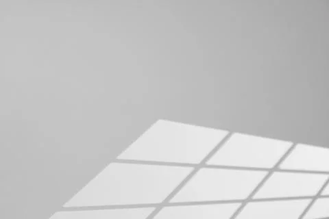 Light and shadow from window on white wall, space for text Stock Photos