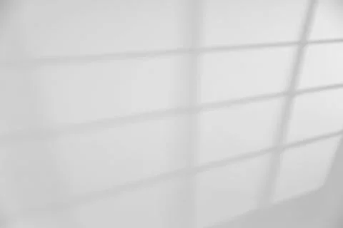 Light and shadow from window on white wall, space for text Stock Photos