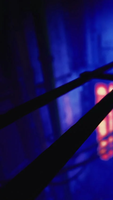 Light and shadows create shapes in a dark space with blue and orange tones Stock Footage 331747844