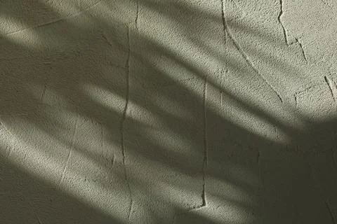 Light and shadows falling on textured wall 스톡 사진