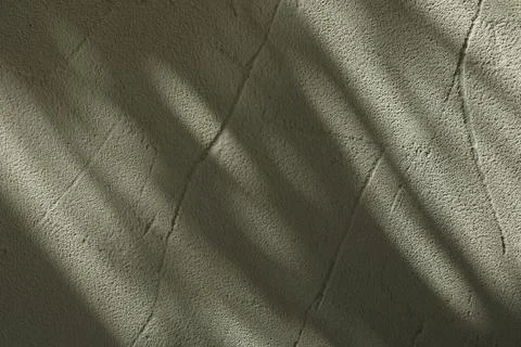 Light and shadows falling on textured wall 스톡 사진