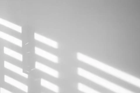 Light and shadows falling on white wall Stock Photos