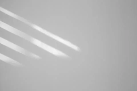 Light and shadows falling on white wall Stock Photos