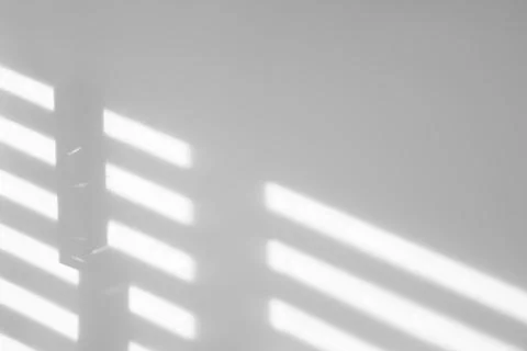 Light and shadows falling on white wall 스톡 사진