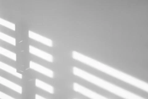 Light and shadows falling on white wall Stock Photos