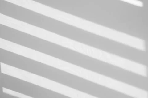 Light and shadows falling on white wall 스톡 사진
