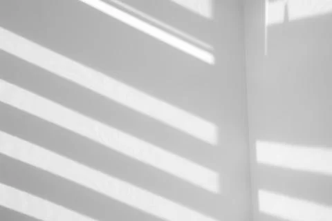 Light and shadows falling on white wall Stock Photos