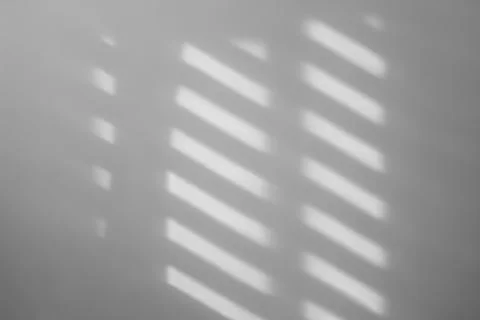 Light and shadows falling on white wall Stock Photos