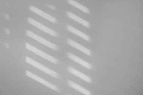 Light and shadows falling on white wall 스톡 사진