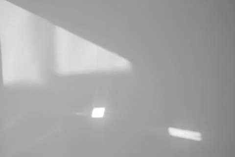 Light and shadows falling on white wall 스톡 사진