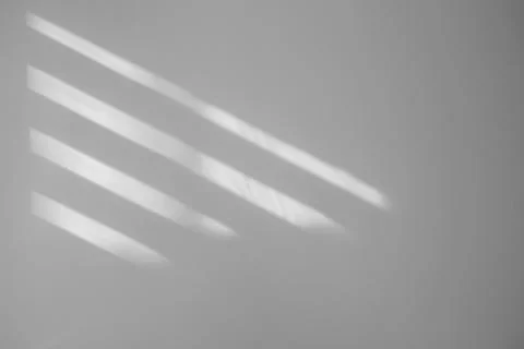 Light and shadows falling on white wall Stock Photos
