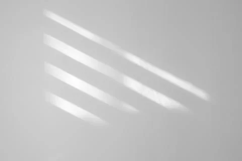 Light and shadows falling on white wall 스톡 사진