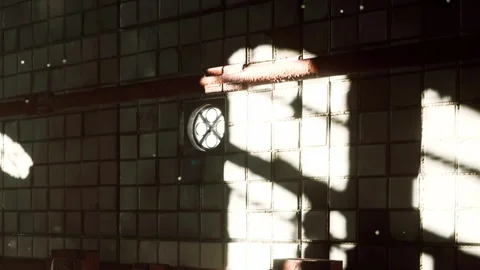 Light and shadows in an old restroom with tiles and pipes during the day Stock Footage 345001904