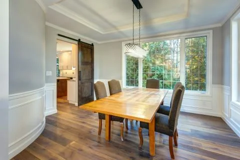 Light and spacious dining room interior in a luxury custom built home. White  Stock Photos