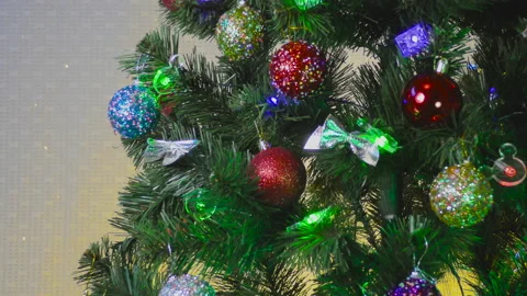 On a light and yellow background, a green Christmas tree Stock Footage 145729433