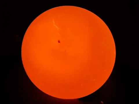 The light is on the back of the egg and the egg is bright yellow. Stock Photos