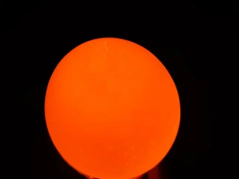 The light is on the back of the egg and the egg is bright yellow. Stock Photos