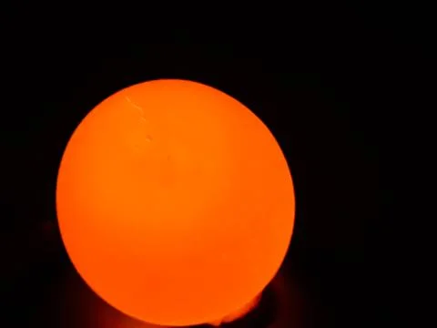 The light is on the back of the egg and the egg is bright yellow. Stock Photos