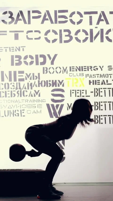 On a light background, a dark figure, the outline of a woman in leggings and top Stock Footage 316592036