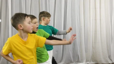 On a light background, four athletes perform punches with a change in stance Stock Footage 149473884