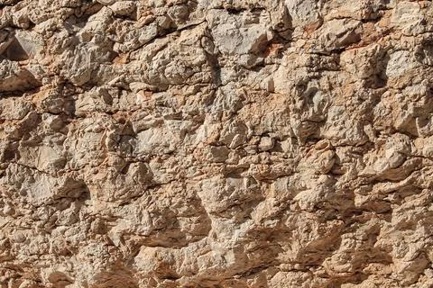 Light background from natural limestone. Texture of natural stone with cracks Stockfoto's