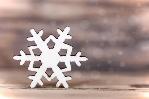 A light background with a single snowflake and bokeh Stock Photos