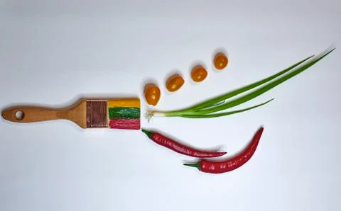 On a light background vegetables and brush with paints close-up horizontally Stock Photos