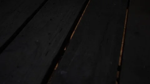 The light from the basement penetrates between the old planks of the hatch. Stock Footage 122821185