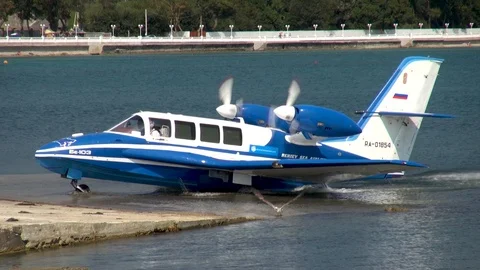 Light Be-103 amphibious aircraft leaves sea on landing gear. Close-up. Stock Footage 125610119