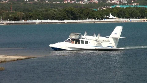 Light Be-103 amphibious aircraft leaves sea on landing gear. Close-up. Stock Footage 125610165