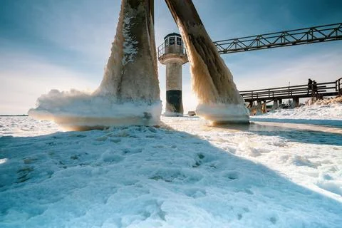Light beacon or lighthouse in winter landscape at a dutch lake Stock Photos