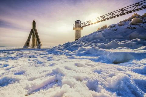 Light beacon or lighthouse in winter landscape at a dutch lake Stock Photos