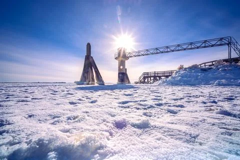 Light beacon or lighthouse in winter landscape at a dutch lake Stock Photos