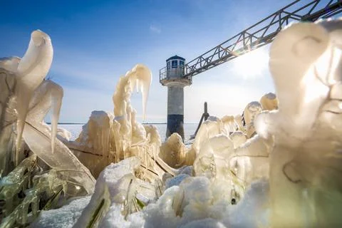 Light beacon or lighthouse in winter landscape at dutch coast. Stock Photos