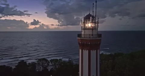 Light beam from lighthouse by Baltic Sea after sunset Stock Footage 301389625