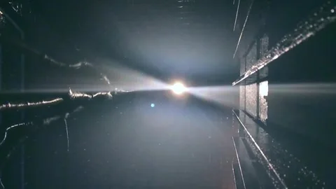 Light beam piercing through dark, misty night while rain drops Stock Footage 336435418