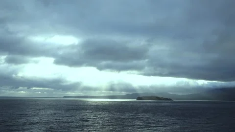 Light Beaming Through Clouds Onto The Ocean With Landscape - Color 2 Stock Footage 255318058