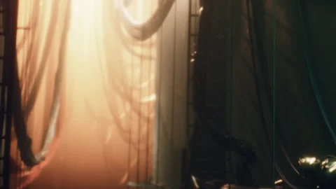 Light beams filter through fabric in a dimly lit space Stock Footage 342818148