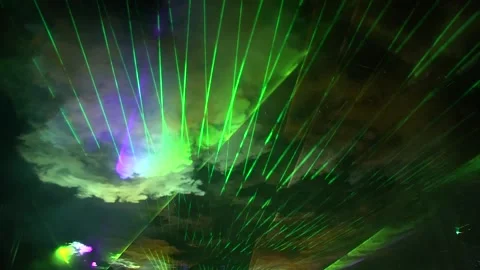Light beams projected into the sky, jets of smoke imagining moving clouds in Vídeos de archivo 145663979