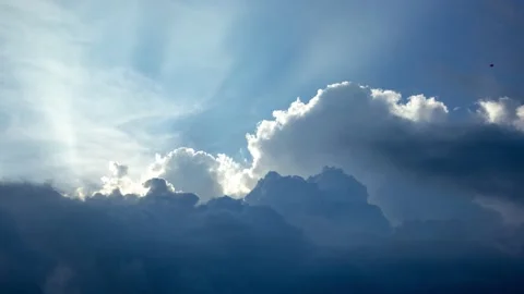 Light Beams Shining Through Rolling Cumulus Clouds in Blue Sky Timelapse Stock Footage 198091223