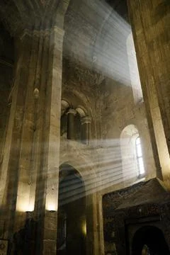 Light Beams Streaming Through Window in Ancient Stone Cathedral Interior Stock Photos