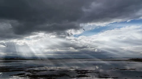 Light beams through clouds over calm ocean,  Reykjavik, Iceland Stock Footage 40699607