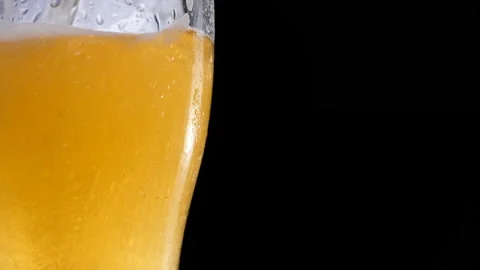 Light beer pouring in glass with bubbles and foam Stock Footage 155355566