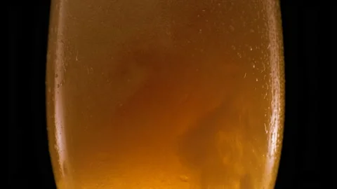 Light beer pouring in glass. With bubbles and foam. Stock Footage 156172234