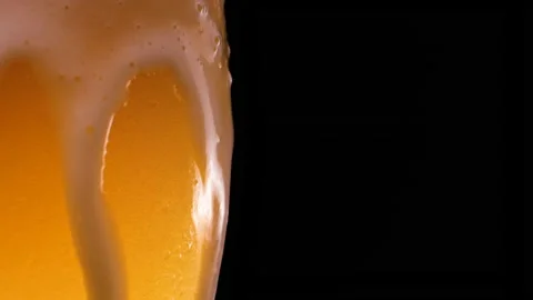 Light beer is pouring into glass. Cold Beer in a glass with water drops.  Stock Footage 153671364