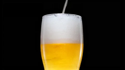 Light beer is pouring into glass. Cold Beer in a glass with water drops Video stock 164029907