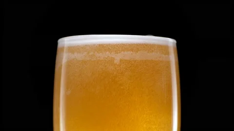 Light beer is pouring into glass. Cold lager beer in a beer mug Stock Footage 164176013