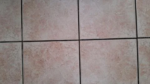 Light beige ceramic floor tiles with dark grey grout lines Stock Photos